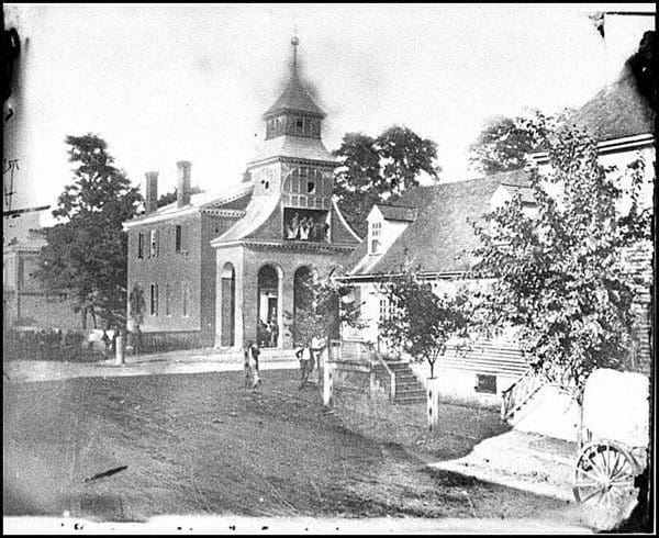 An old photograph of a building with a clock tower.