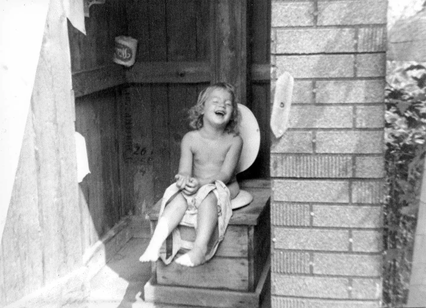 A child sitting on a toilet.