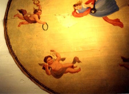 A painting of angels and cherubs on a ceiling.