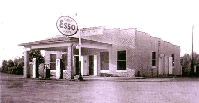 A black and white photo of a gas station.