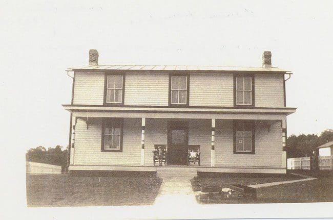 A large house with two windows and a porch.