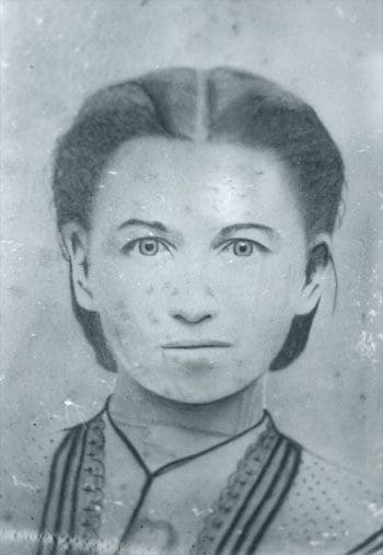 A black and white photo of a woman 's face.