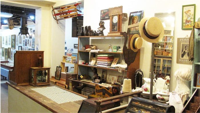 A room filled with lots of wooden shelves and various items.