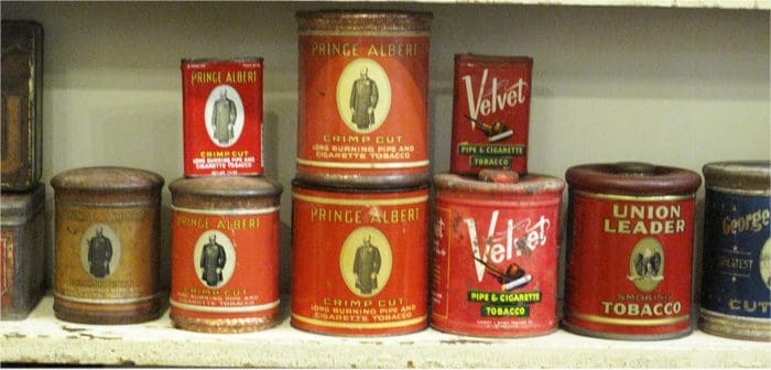 A shelf with several different types of spice tins.