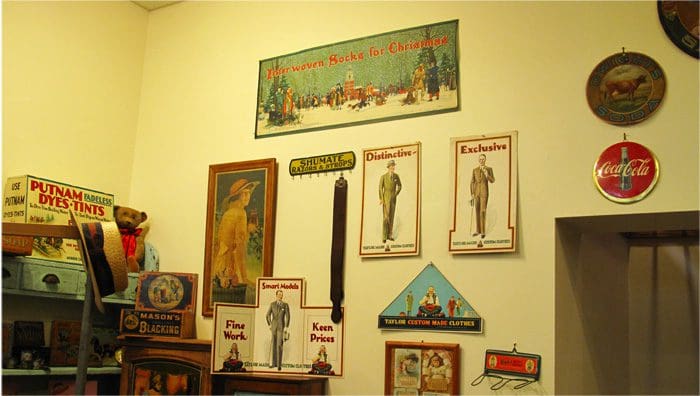 A wall with many pictures and other items on it