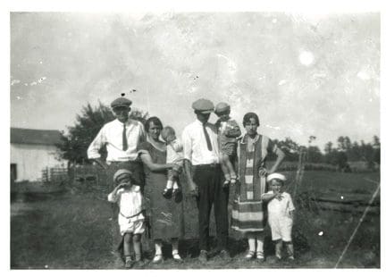 A family posing for a picture in an old photo.