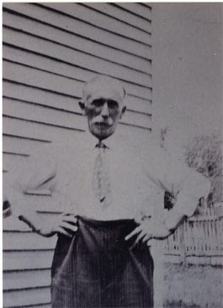 A man standing in front of a building.