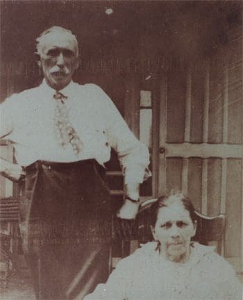 A man and woman standing in front of a building.