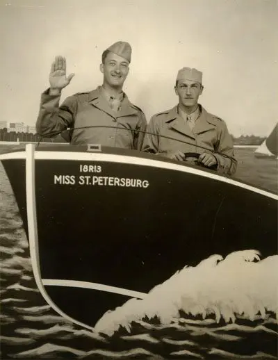 Two men in military uniforms are on a boat.