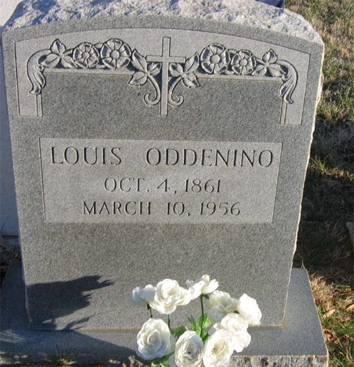 A grave with flowers on top of it.