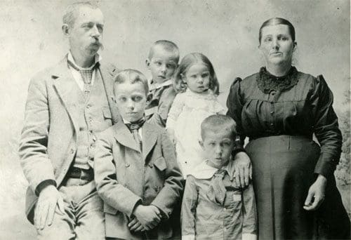 A family of six posing for a picture.