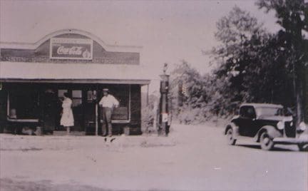 A black and white photo of people standing outside.