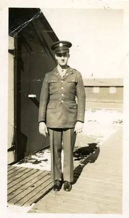 A man in uniform standing on the dock.