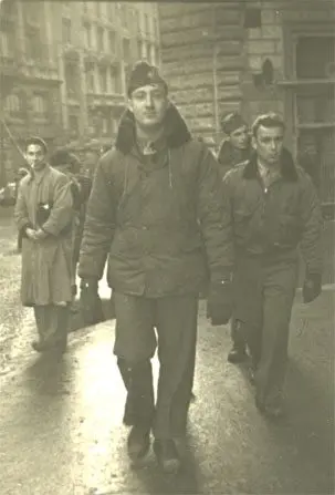 A man in a parka walking down the street.