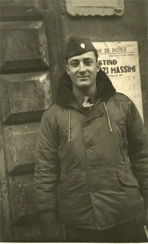 A man in a parka standing next to a wall.