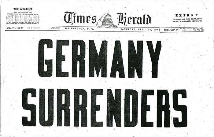 A newspaper with the headline germany surrenders.