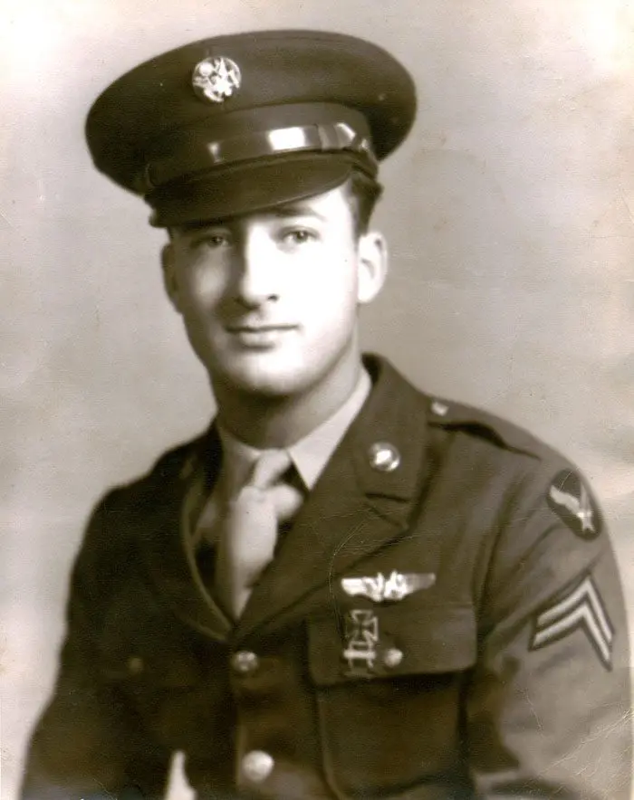 A man in uniform is posing for a photo.