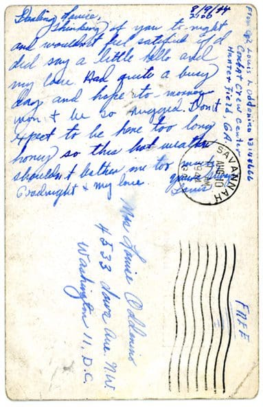 A postcard with the letter written in blue ink.