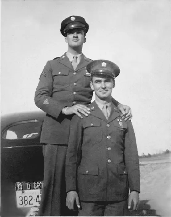 Two men in uniform posing for a picture.