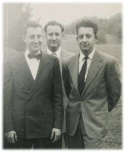 Three men in suits and ties standing next to each other.