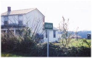 A street sign in front of some houses