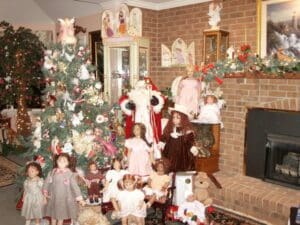 A group of children standing around a christmas tree.