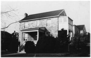 A black and white photo of an old house.