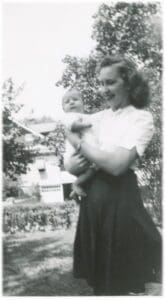 A woman holding a baby in her arms.