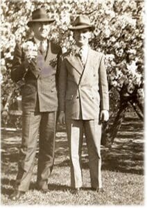 Two men in suits standing next to each other.