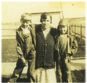 A man and two boys standing next to each other.