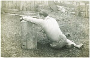 A man sitting on the ground with his arms crossed.