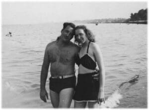 A man and woman standing in the water.