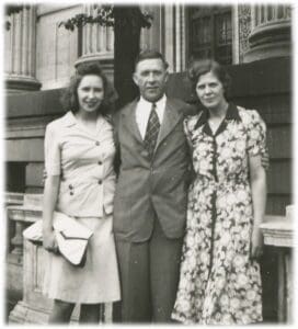 A man and two women standing next to each other.