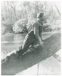 A man climbing on the side of a tree.