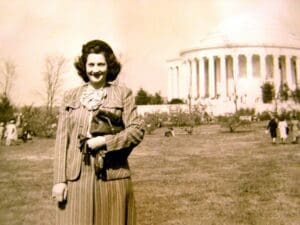 A woman standing in front of the jefferson memorial.