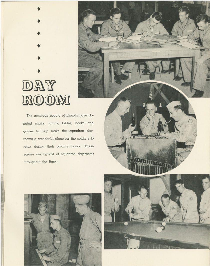 A black and white photo of men in uniform in a day room.