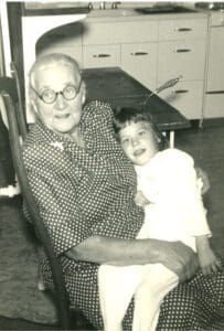 An old black and white photo of an older woman and a little girl.