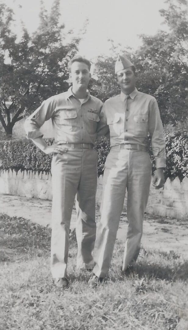 Two men in military uniforms standing next to each other.