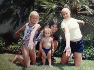 Three women and a baby posing for a picture.